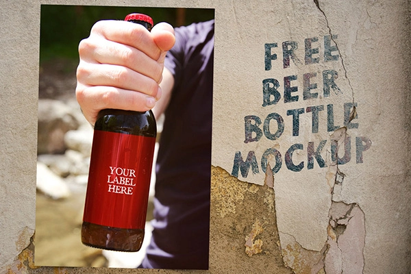 Free Beer Bottle in Hand Mockup PSD