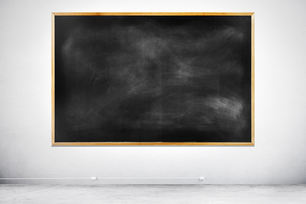Blank Black Chalkboard on a White Wall - Free Photo